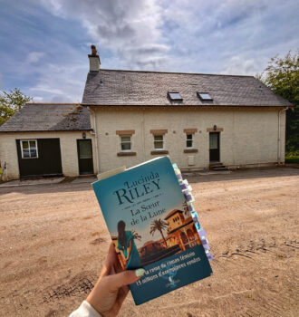 Main tenant La soeur de la lune devant un cottage à coté de la maison principale d'Alladale