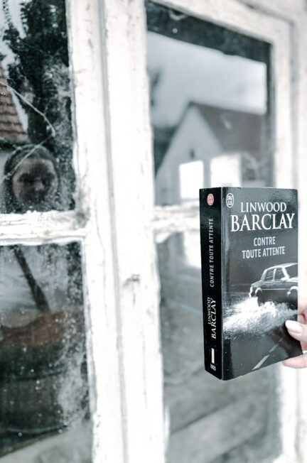 Contre toute attente de Linwood Barclay tenu devant la fenêtre d’une maison abandonnée.